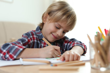 Poster - Little boy drawing at table indoors. Creative hobby