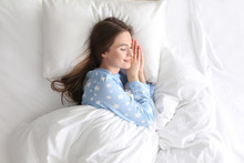 Young Woman Sleeping On Comfortable Pillow In Bed At Home, Top View