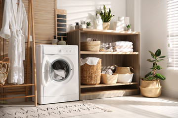 Modern washing machine and shelving unit in laundry room interior