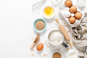 Poster - Baking homemade bread on white kitchen worktop with ingredients for cooking, culinary background, copy space, overhead view