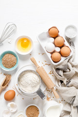 Poster - Baking homemade bread on white kitchen worktop with ingredients for cooking, culinary background, copy space, overhead view