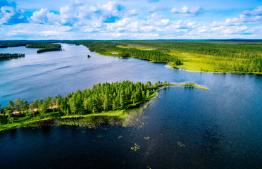 Wall Mural - Aerial top view of blue lakes with islands and green forests in Finland.