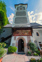 Exterior View Of The Bell Tower Of The Roman Catholic Parish Church Of Hallstatt, OÖ, Austria, And It's Beautiful Fresco Above The Church's Entrance