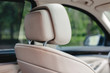Beige leather car seat headrest.