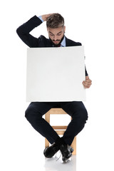 Canvas Print - young businessman in suit holding empty board