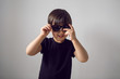 © saulich84 - boy in a black t-shirt stands at home against the background of a white room