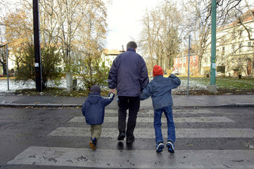 Children with parent on zebra crossing