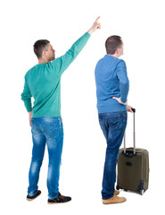 Poster - Back view of two man in sweater with suitcas.