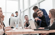 © ASDF - young businessman sitting at office Desk and pointing at you