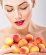 © Svetlana Fedoseeva - Beautiful woman holding a juicy apricots. Perfect skin. Professional makeup.