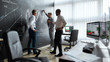 © Svitlana - Having advanced level teachers. Full-length shot of diverse employees, traders discussing the strategy of work, while standing near blackboard full of charts. Horizontal shot