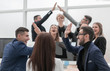 © ASDF - group of young business people giving each other a high five