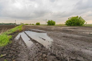 Hole in road with cloudy sky