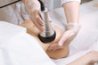 Beautician makes the procedure cavitation of a young beautiful girl. The concept of skin care face and body