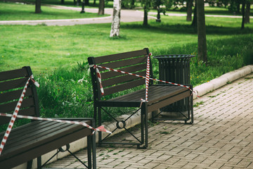 closed park in Moscow, benches wrapped in red ribbon, no seating, quarantine 