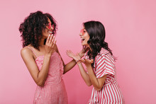 Funny Story Made Two Friends Laugh Heartily. Portrait Of Girls In Pink Striped Outfits Who Are Having Fun