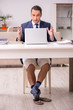 © Elnur - Young male employee working at home during pandemic disease
