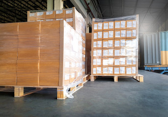 Wall Mural - Large shipment pallet goods at interior warehouse dock. Package boxes on pallets. truck docking load cargo at warehouse. Road freight delivery logistics shipping and transport.