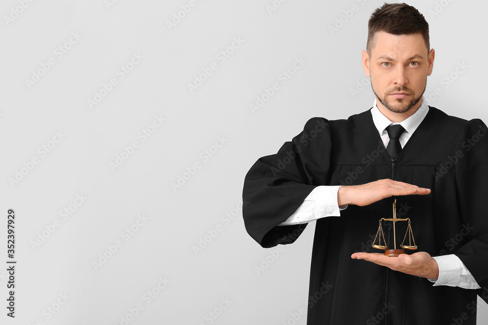 Male judge on light background