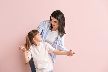 Sticker - Happy woman with little adopted girl on color background