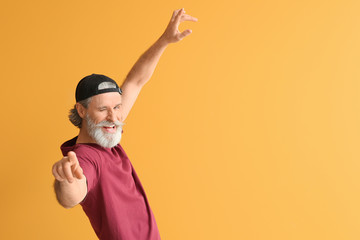 Sticker - Cool senior man dancing against color background