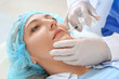 © Pixel-Shot - Woman receiving filler injection in beauty salon