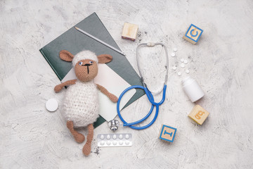 Wall Mural - Stethoscope, stationery, pills and toys on white background