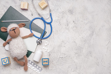 Wall Mural - Stethoscope, stationery, pills and toys on white background