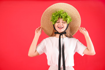 Wall Mural - Young woman with lettuce on color background. Diet concept