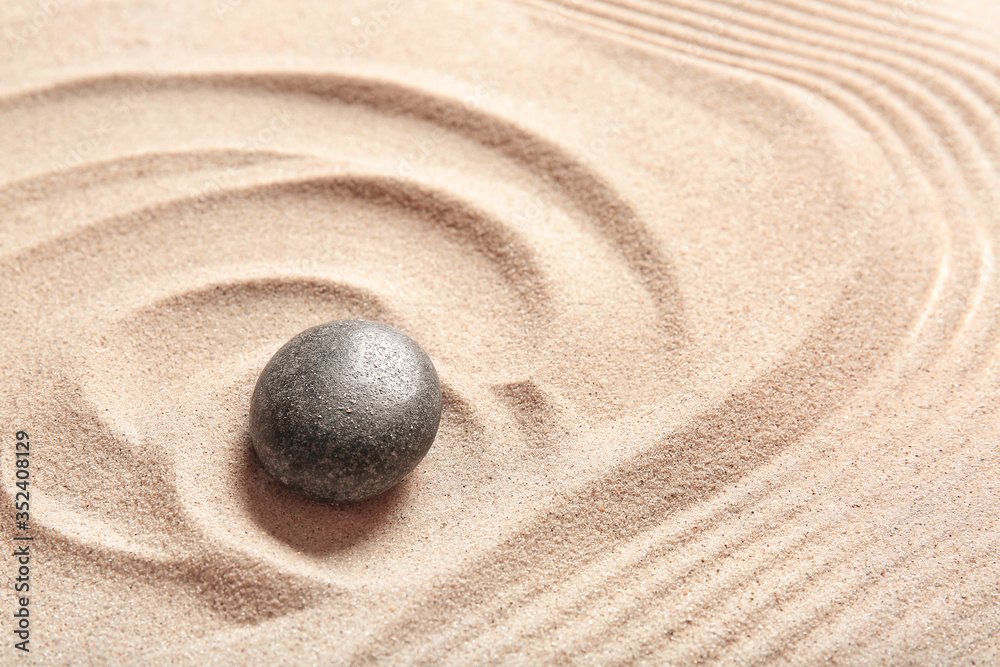 Stone on sand with lines. Zen concept