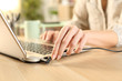 © PheelingsMedia - Woman hands plugging battery charger on laptop