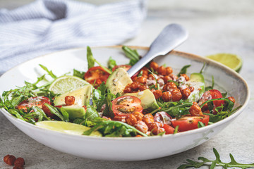 Canvas Print - Roasted chickpea salad with avocado and tomatoes in white bowl. Healthy vegan food concept.