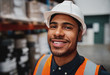 © StratfordProductions - Portrait of smiling warehouse supervisor wearing white helmet hard hat smiling at the camera