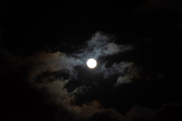 a full moon with clouds in the black night sky. full moon on january 31, 2018. a supermoon. beautifu