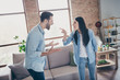 © deagreez - Frustrated outraged spouses have scandal woman know her husband cheat point index finger blame man scream in comfort cozy house indoors near couch sofa