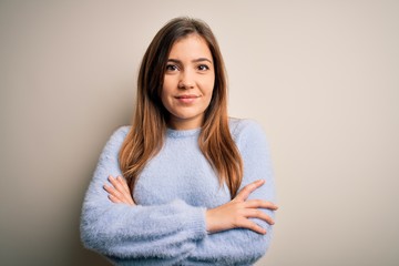 Canvas Print - Beautiful young woman wearing casual winter sweater standing over isolated background happy face smiling with crossed arms looking at the camera. Positive person.