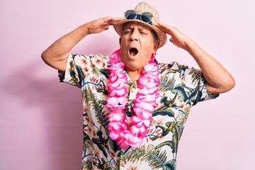 Sticker - Senior handsome grey-haired man on vacation, wearing summer look with Hawaiian lei flowers with hand on head, headache because stress. Suffering migraine.