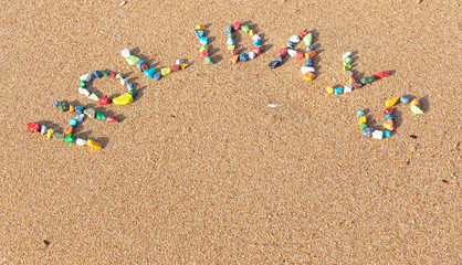 Wall Mural - Summer concept with sandy beach, shells and colored stones