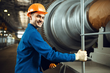 Wall Mural - Engineer on factory, large turbine on background