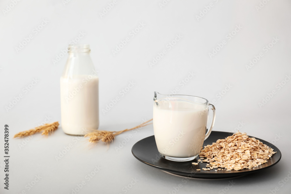 Tasty oat milk on light background