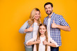 © deagreez - Photo wife beautiful mom lady handsome husband dad guy couple little school girl daughter happy together raise thumb fingers up wear casual clothes isolated yellow color background