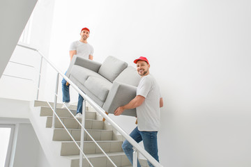 Wall Mural - Loaders carrying furniture in the stairway