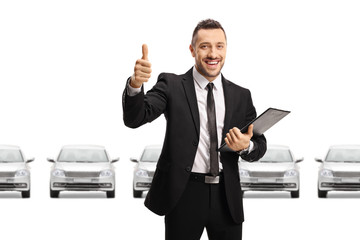 Poster - Car dealer showing thumbs up in a car showroom