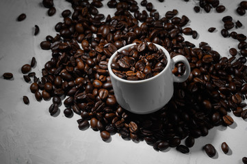 A cup of espresso with coffee beans on a white background