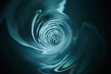 Smooth and beautiuful blue vortex. Whirlpool, water swirl, top view. High speed liquid photography.