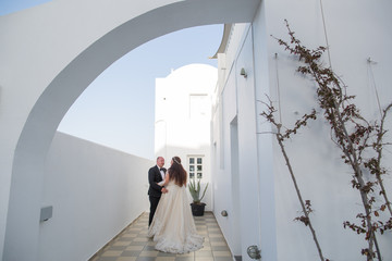 beautiful wedding couple posing in beautiful white city