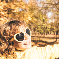 Poster - Happy child having fun outdoor in autumn park