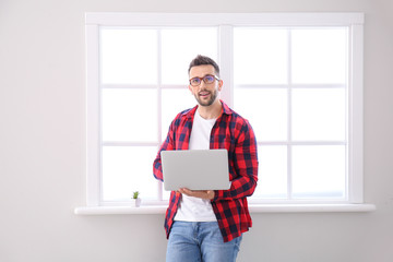 Poster - Young man with laptop working at home