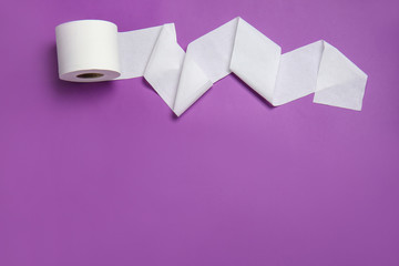 Roll of toilet paper on color background