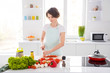 © deagreez - Photo of housewife attractive focused chef lady arms holding tomato cutting knife slices enjoy morning cooking tasty yummy dinner wear apron stand modern kitchen indoors